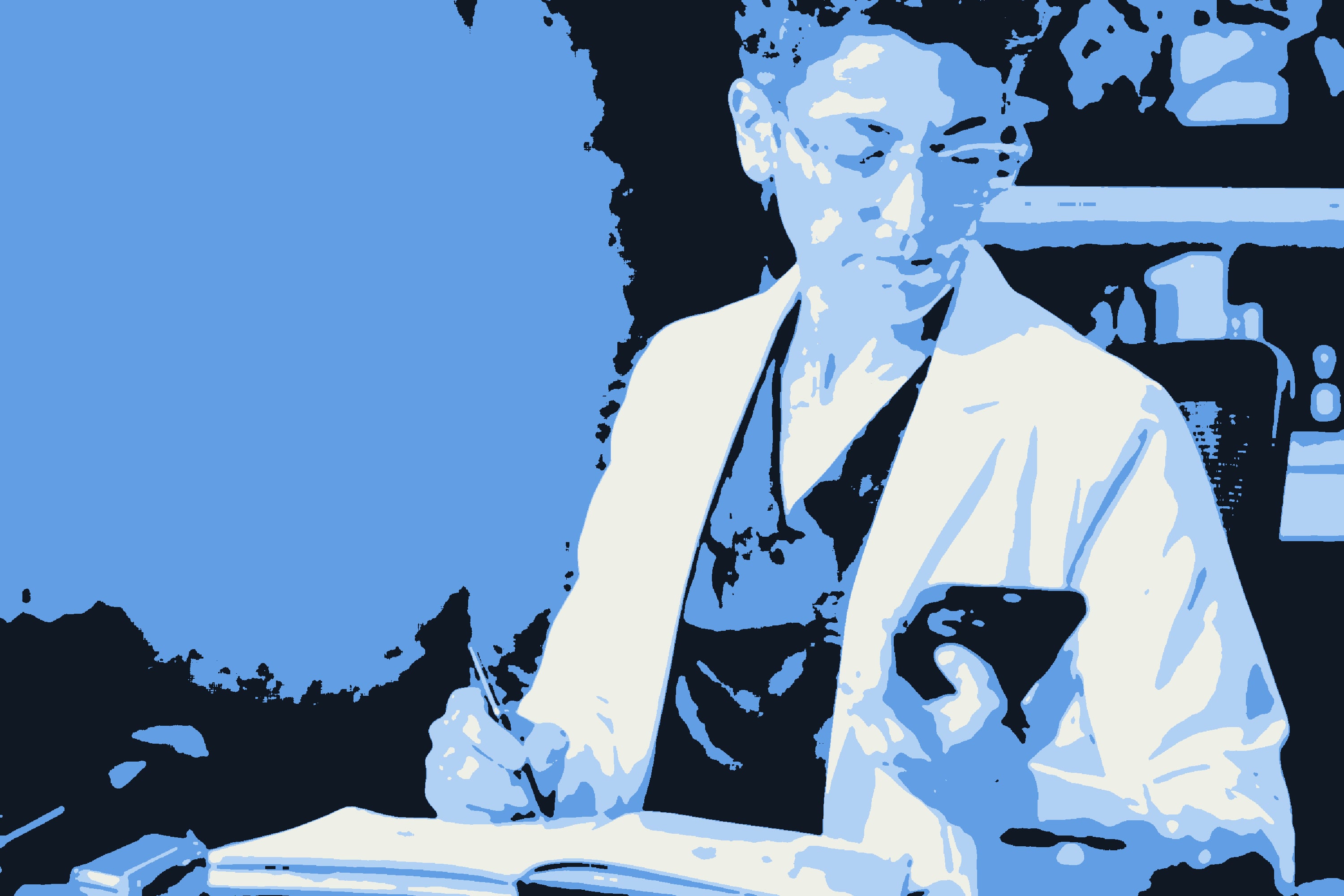 A physician in a white coat writing in a notebook while checking her phone.